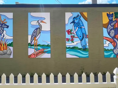 Four Indigenous art pieces on exterior wall of Scugog Arts building