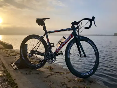 bike on pier during sunset